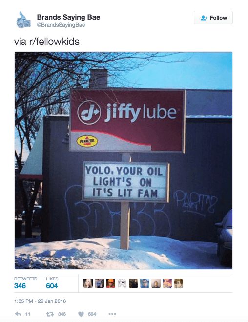 A sign from Jiffy Lube that says "YOLO YOUR OIL LIGHT'S ON IT'S LIT FAM"